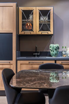 Elegant kitchen with wooden cabinets and marble tabletop, perfect for contemporary homes.