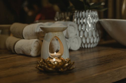 White Candle Holder on Wooden Surface