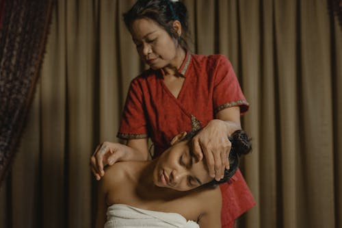 A Masseuse Massaging a Woman