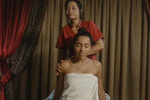 A Masseuse Massaging a Woman