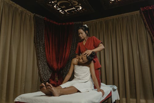 
A Masseuse Massaging a Woman