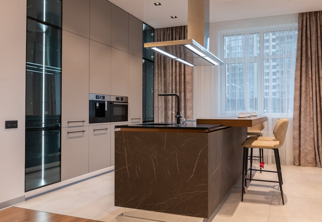 Interior of modern kitchen with furniture in daytime