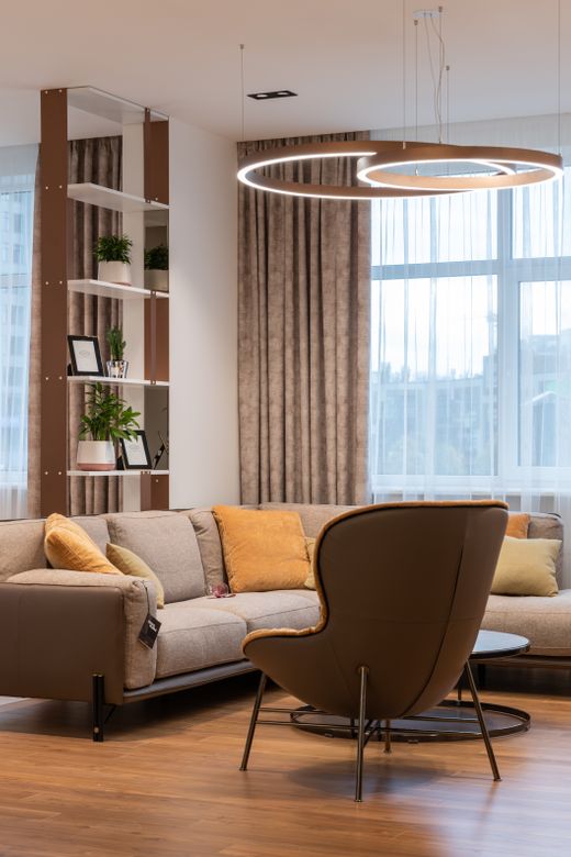 Sunlit living room with a low couch and a window — photo by Max Vakhtbovych on Pexels