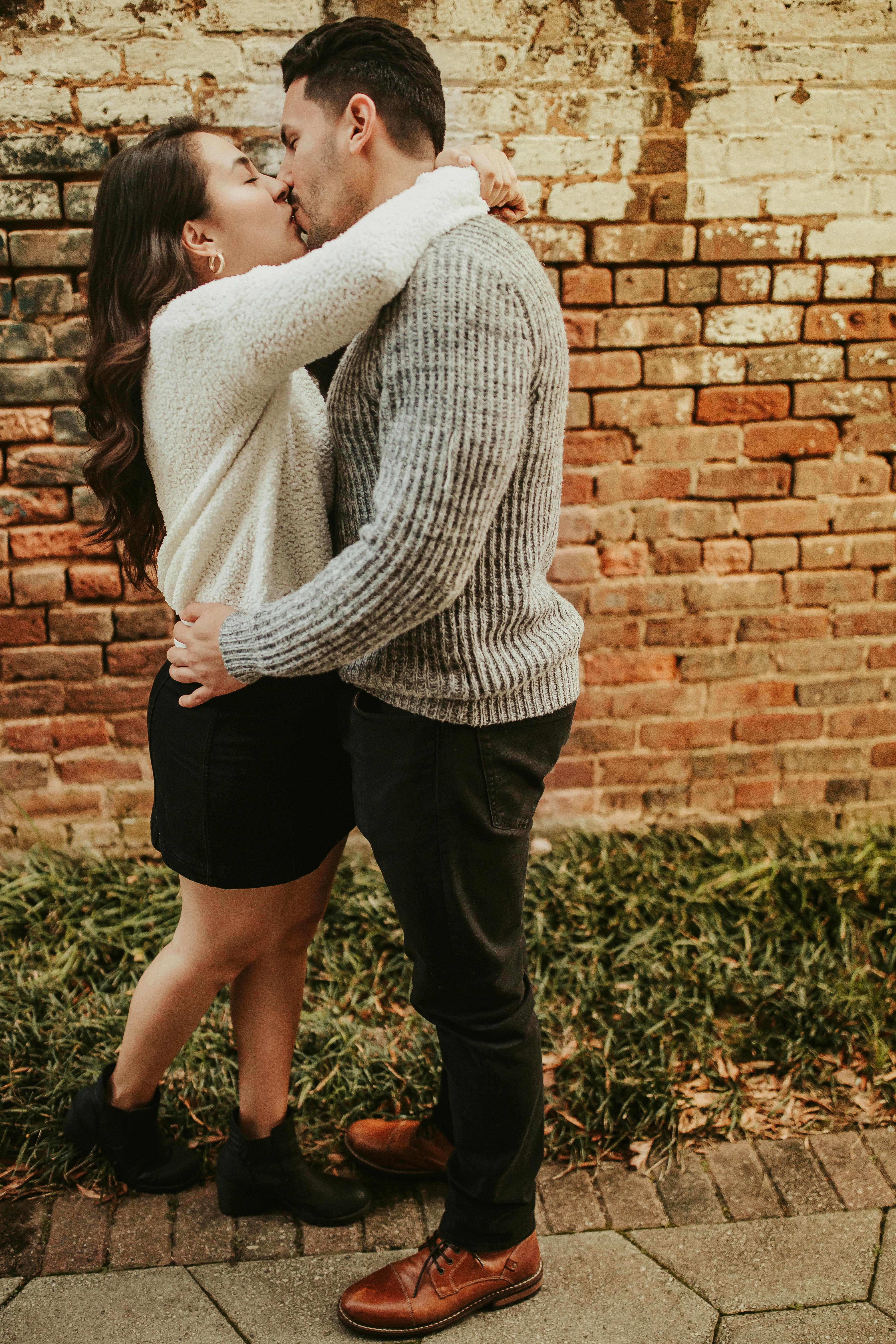 Couple standing on street while kissing · Free Stock Photo