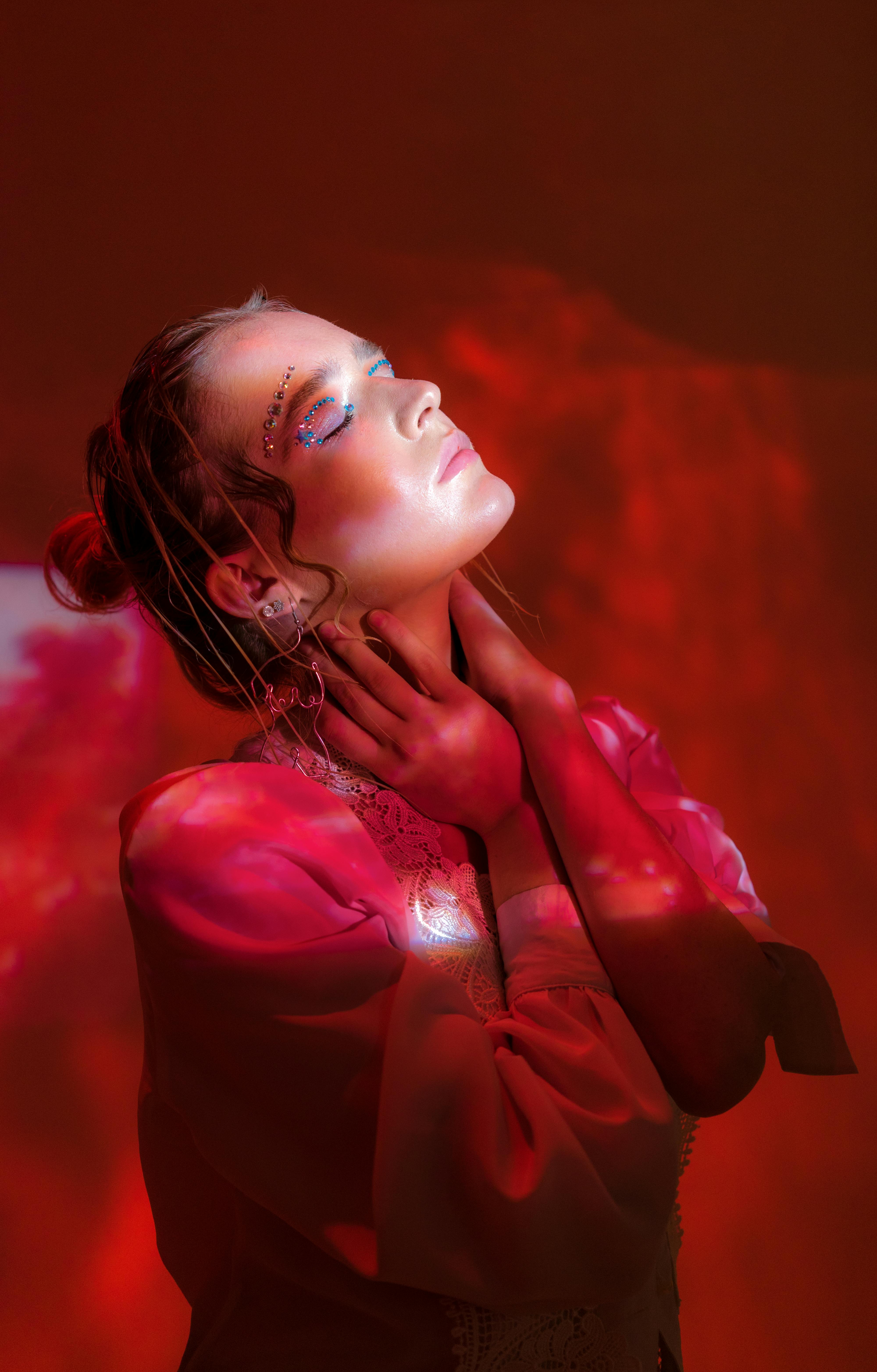 Pensive lady in studio surrounded with red smoke and shades · Free ...