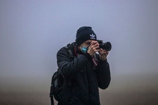 A Man Taking a Photo with His Camera