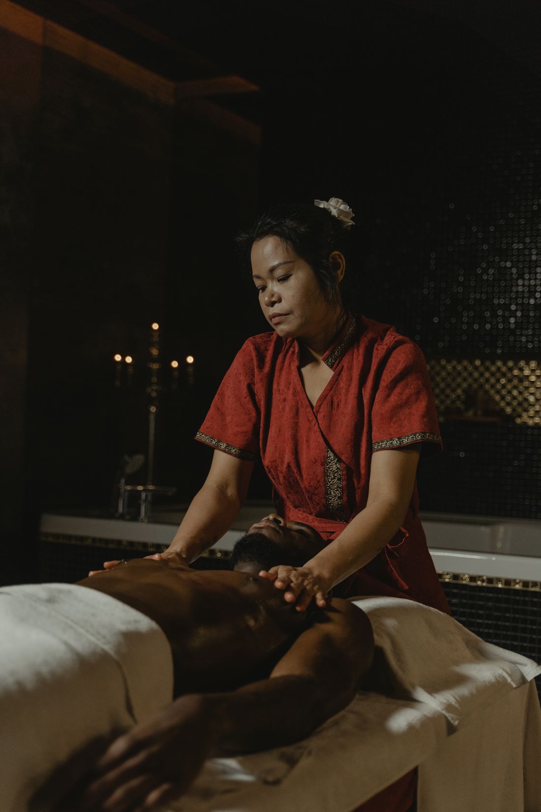 Asian spa therapist giving traditional body massage