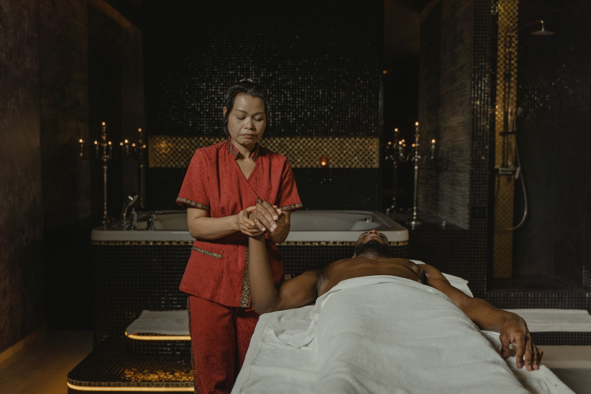 A serene spa therapy session featuring a masseuse providing a relaxing massage treatment to a client.