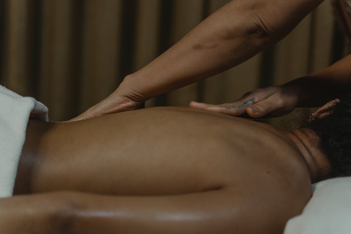 A person receives a deep tissue massage for back relief.