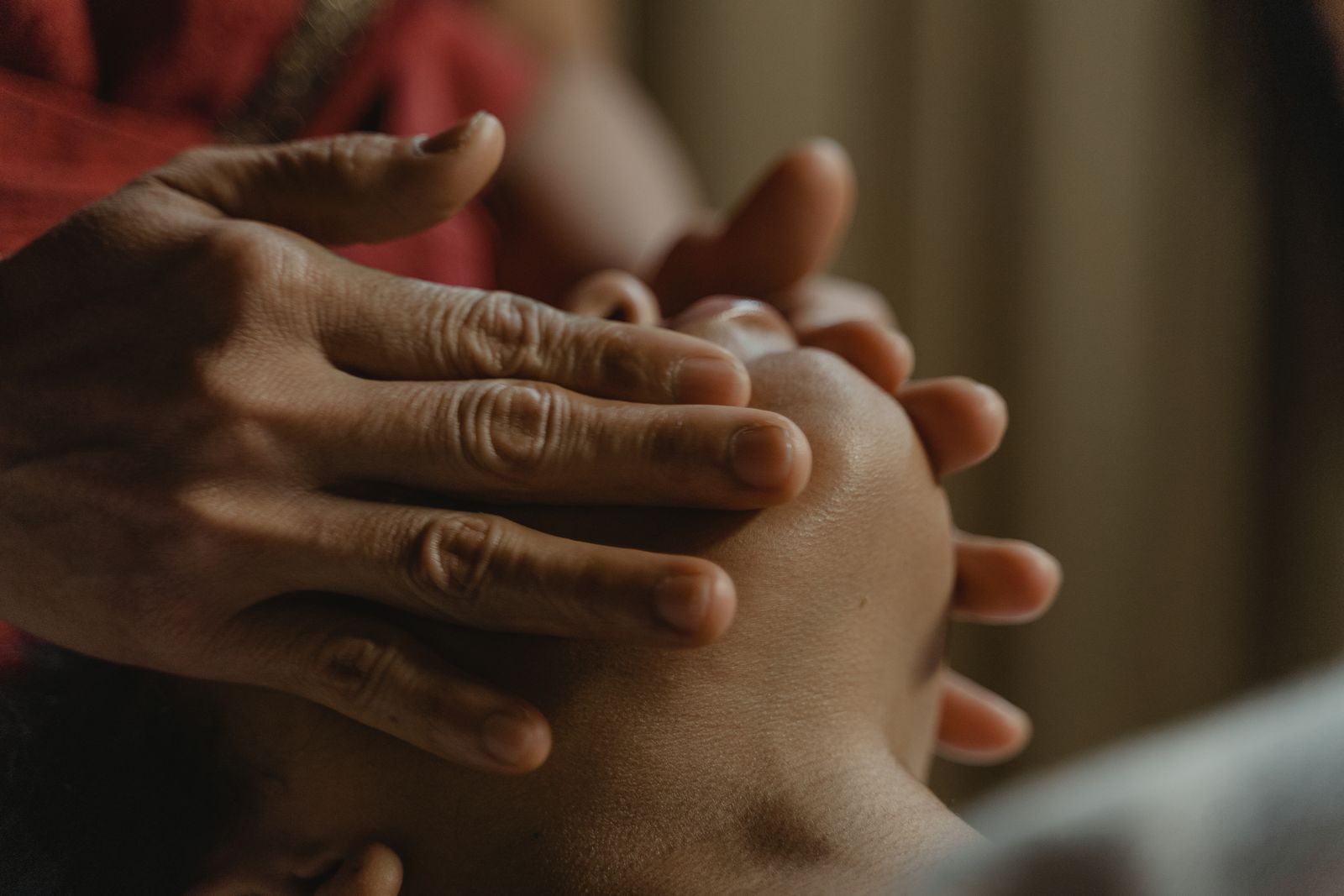 Close-up of hands giving a slow, relaxing facial massage