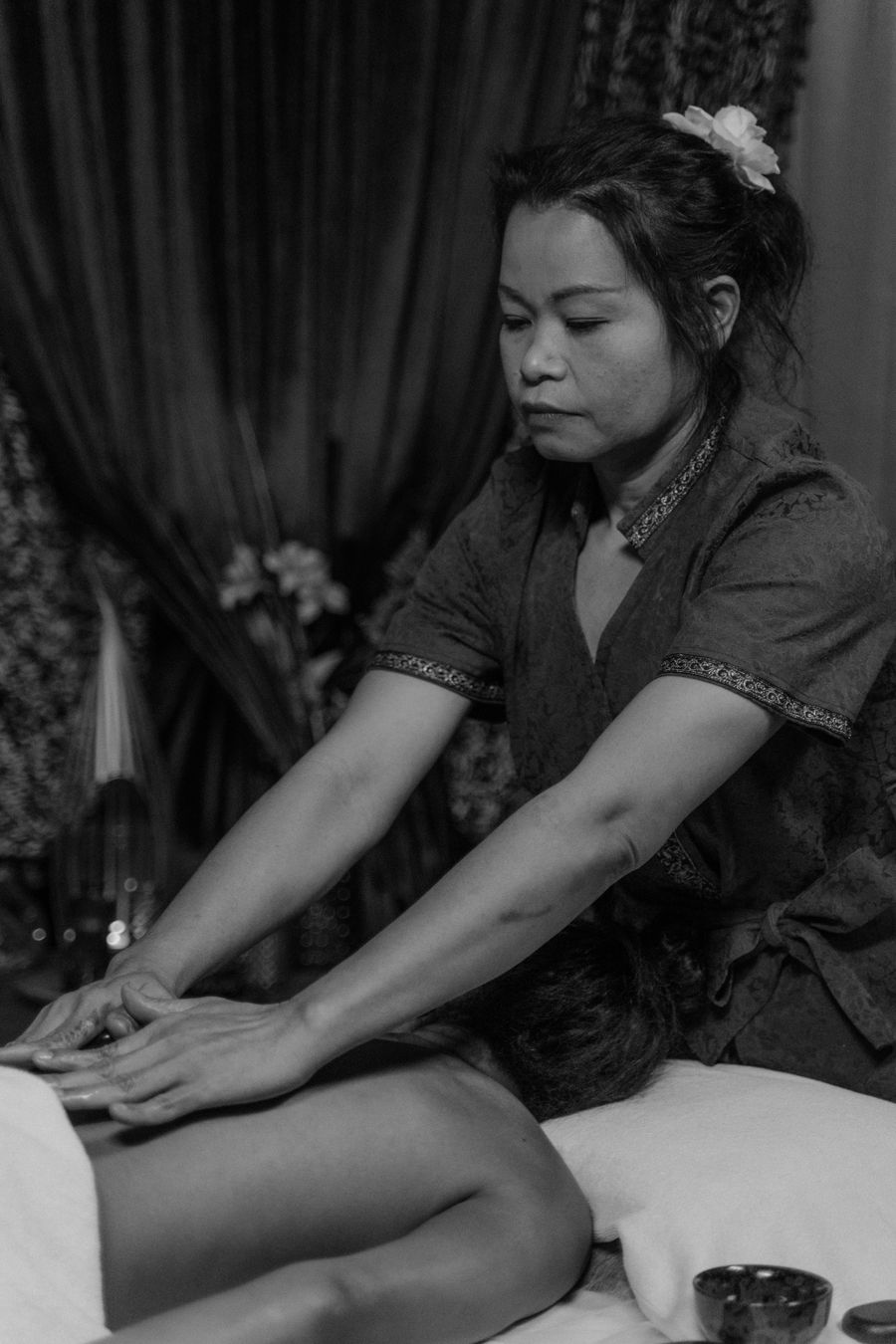 Female therapist giving a professional back massage to a male client in a spa room