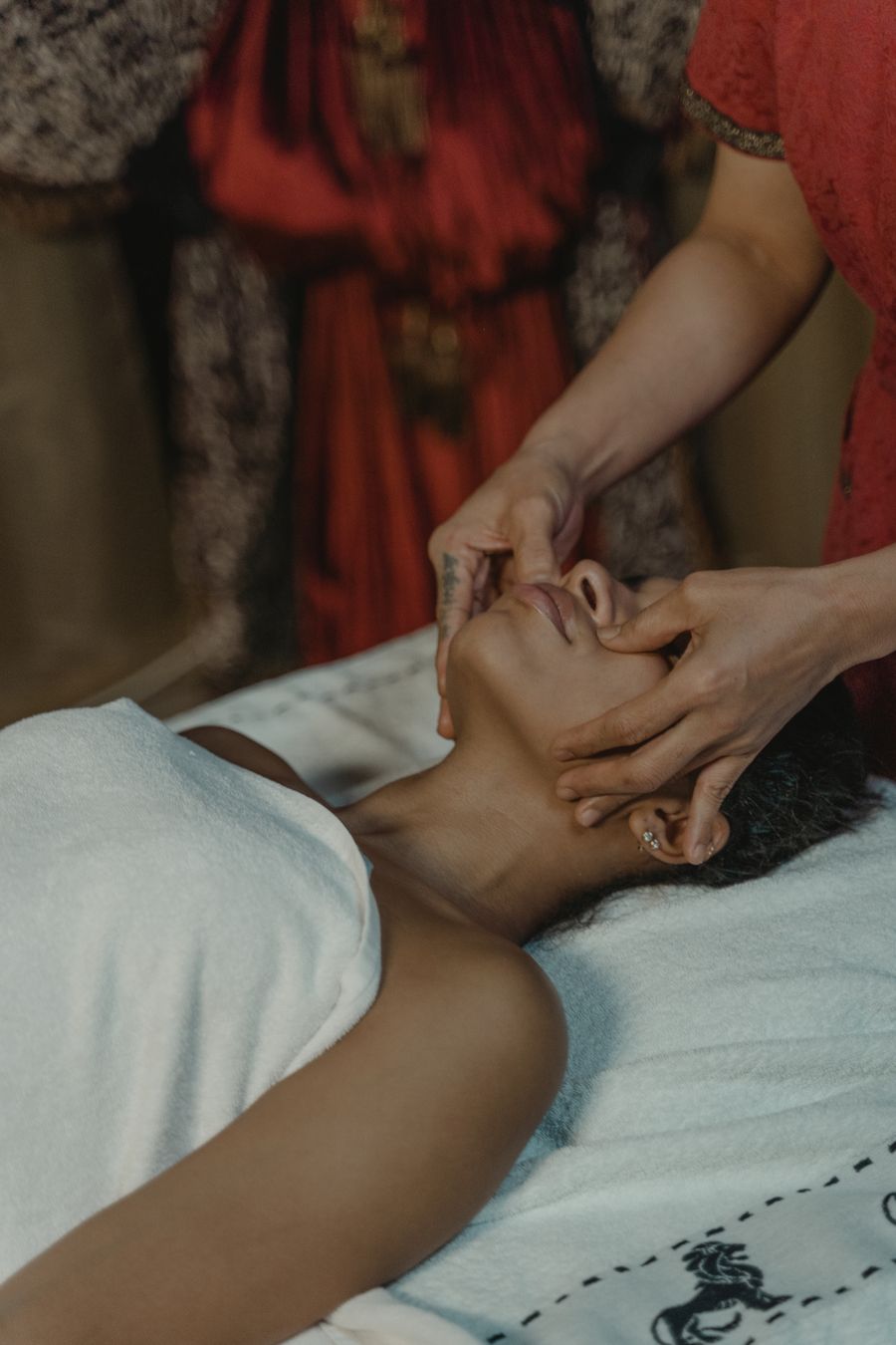 Female massage therapist working on a male client during a relaxation session