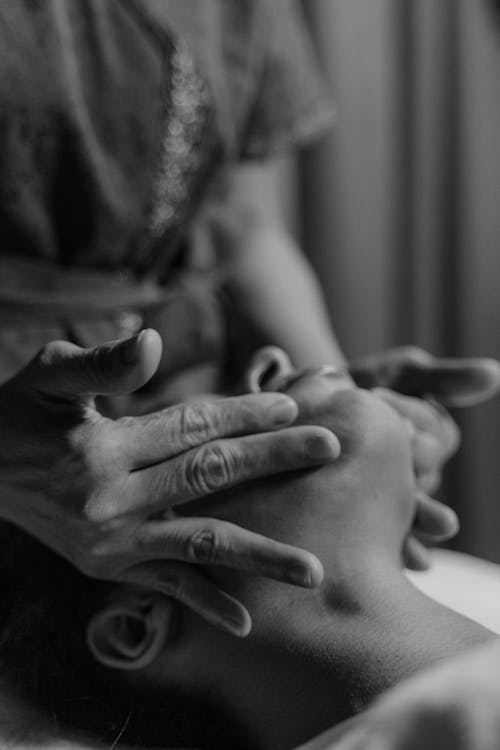 Free Grayscale Photo of a Person's Hands Massaging a Person's Face Stock Photo