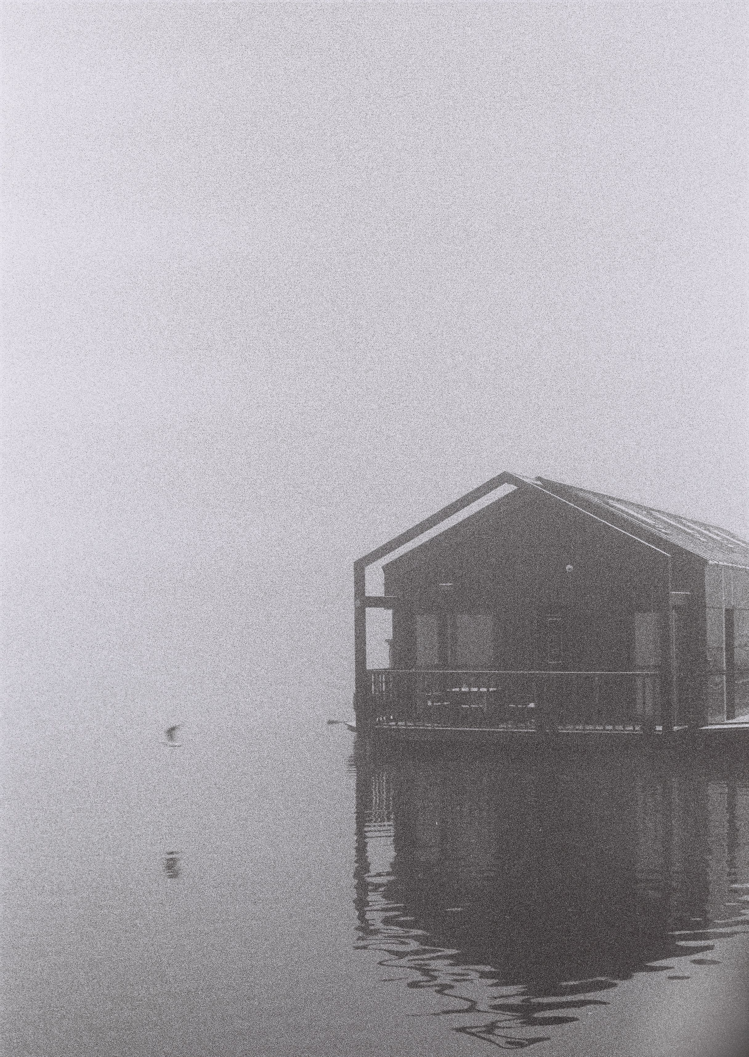 Grayscale Photo of House on Water · Free Stock Photo