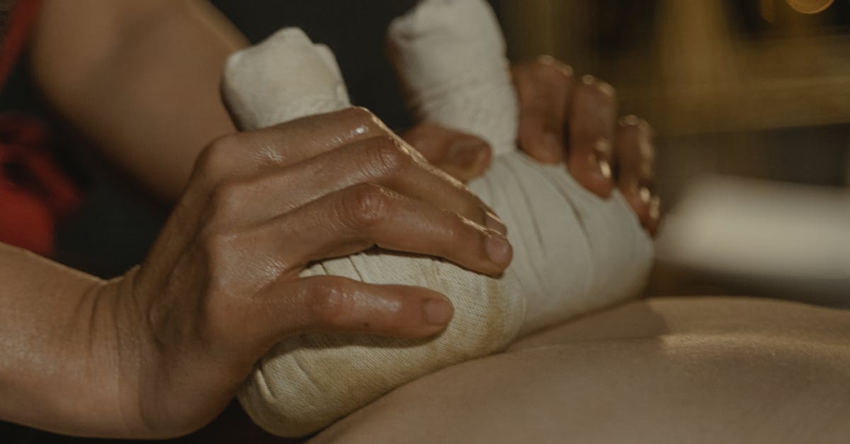 A massage therapist demonstrating deep tissue massage on a client's back.