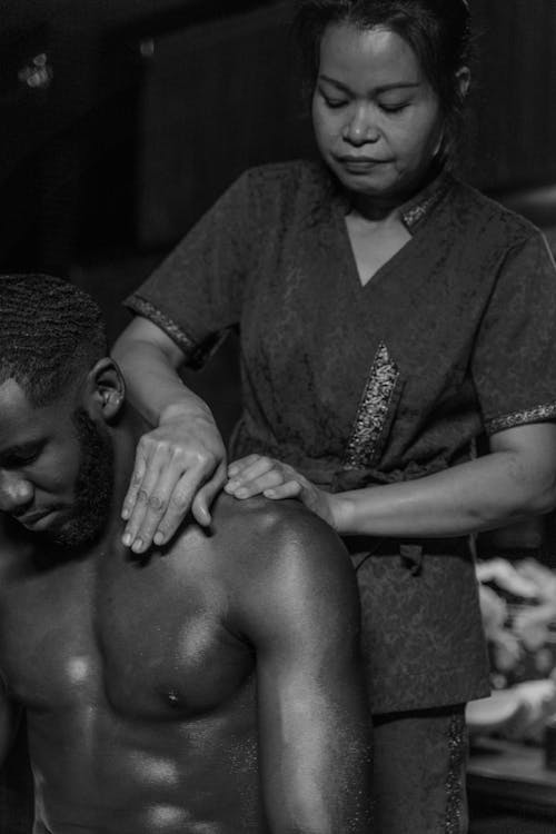 A Masseuse Massaging a Man