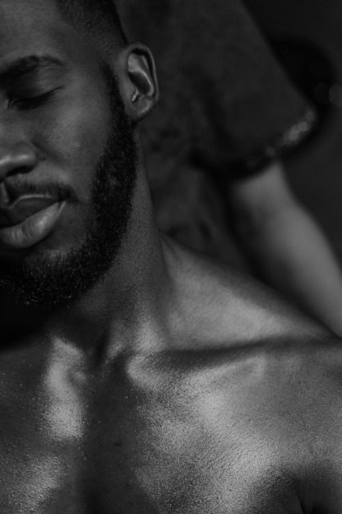 Free Monochrome portrait capturing the serene expression of a shirtless man with a beard. Stock Photo