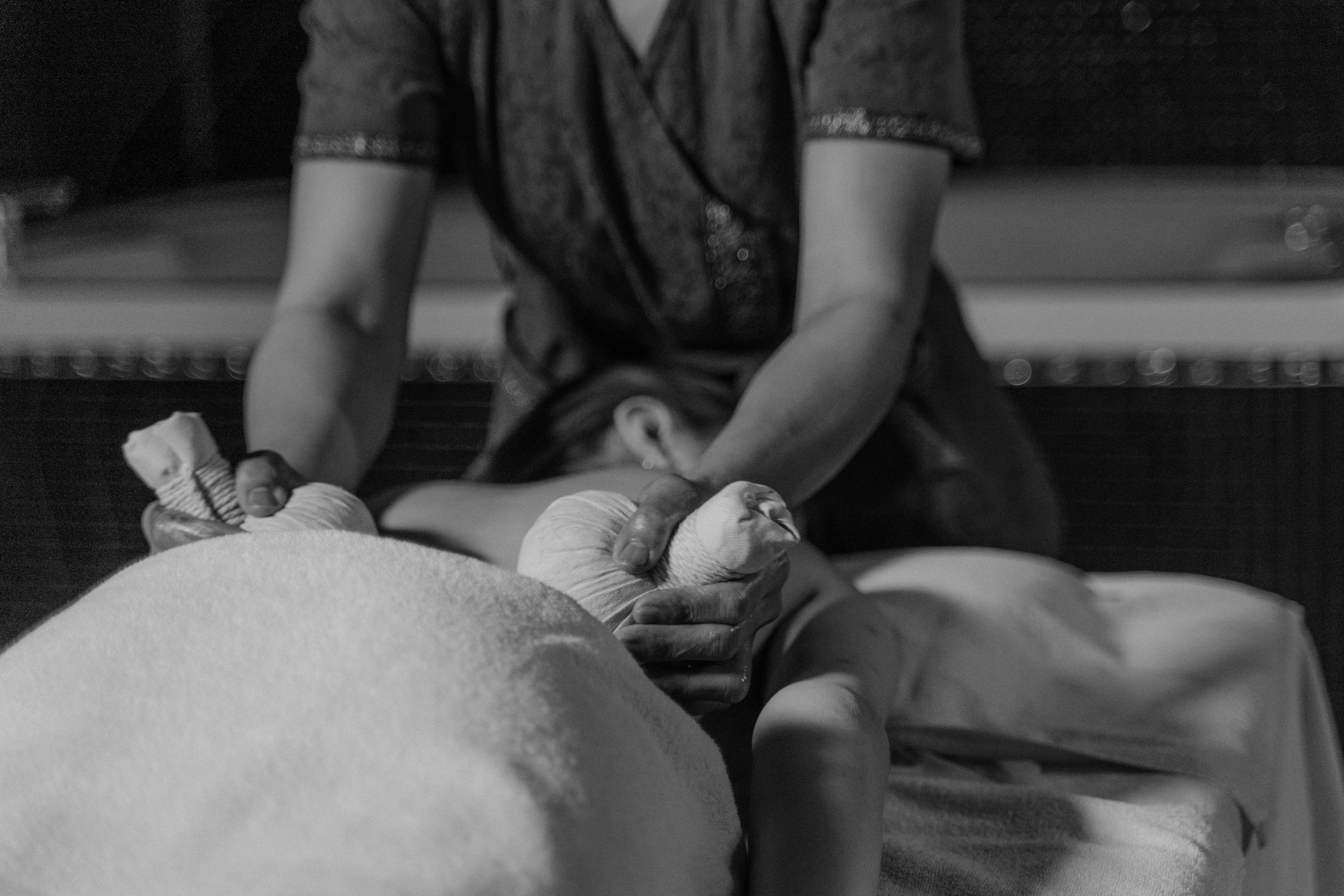 a masseuse massaging a woman