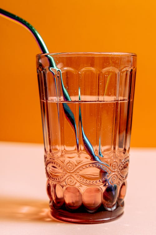 
A Close-Up Shot of a Glass of Water with a Straw