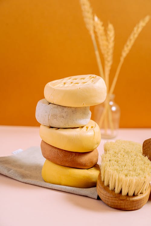 Stacked Soap Bars beside Brushes