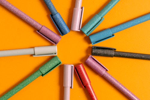 Colorful Pens on Orange Background