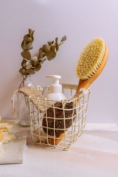 Aesthetic arrangement of bath essentials including brush, sponge, and plant in a cozy setting.