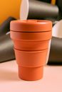 Orange Plastic Cup on White Table