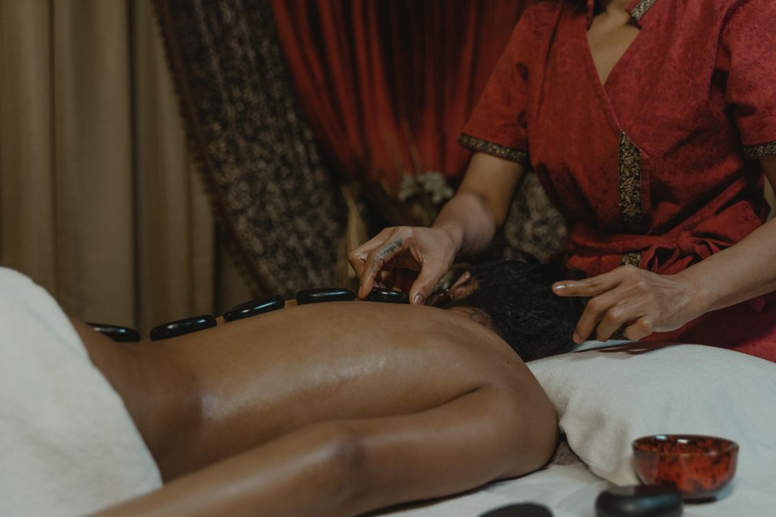 heated stone massage session with basalt stones on the back