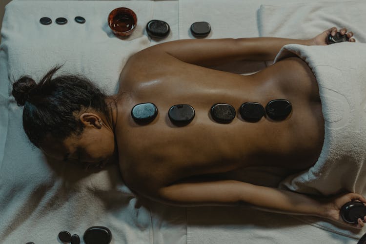 Naked Woman With Hot Stone Massage On Her Back