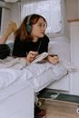Woman Wearing Wireless Headset Holding a Notebook