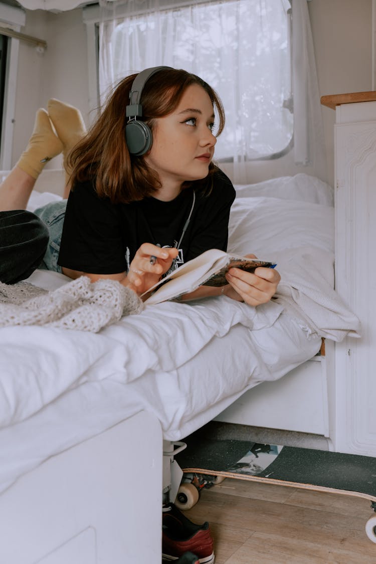 Woman Wearing Wireless Headset Holding A Notebook