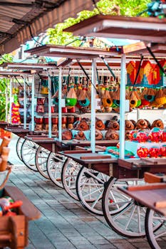 Vibrant display of traditional souvenirs on wooden carts in an outdoor market setting.