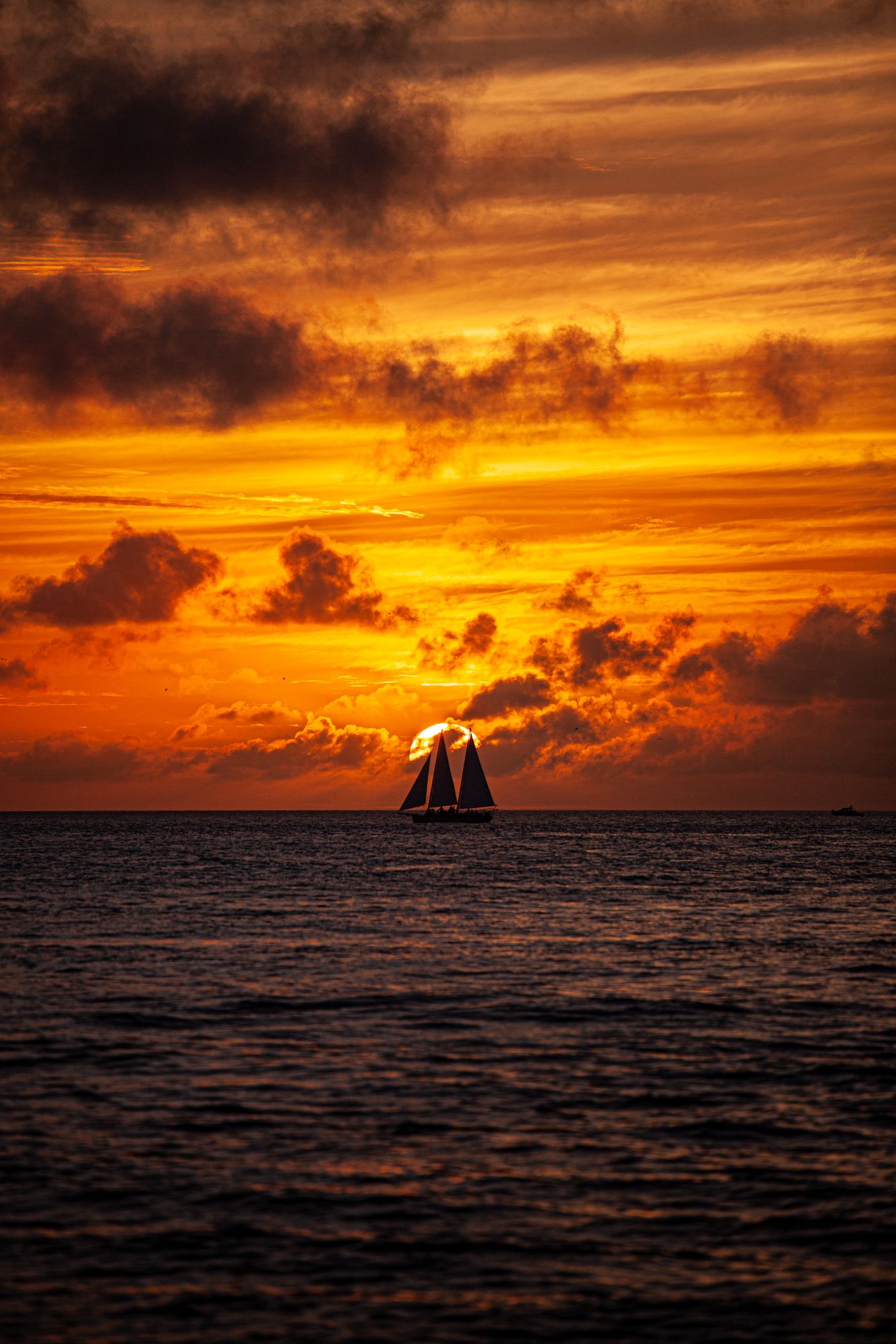 Serene sailboat silhouette on the ocean at sunset
