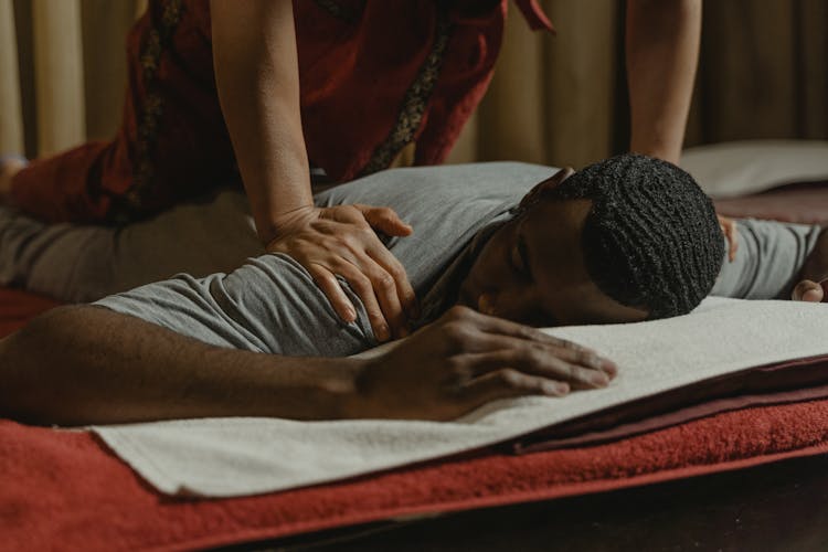 A Man In Gray T-Shirt Having A Body Massage