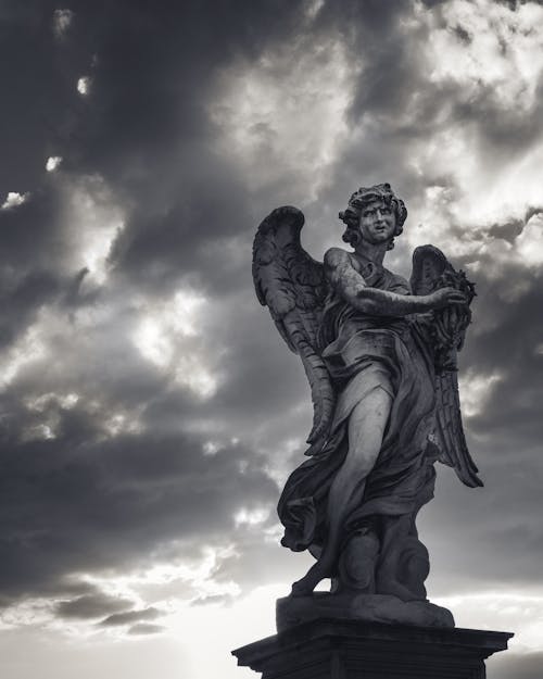 A Statue Under Cloudy Sky