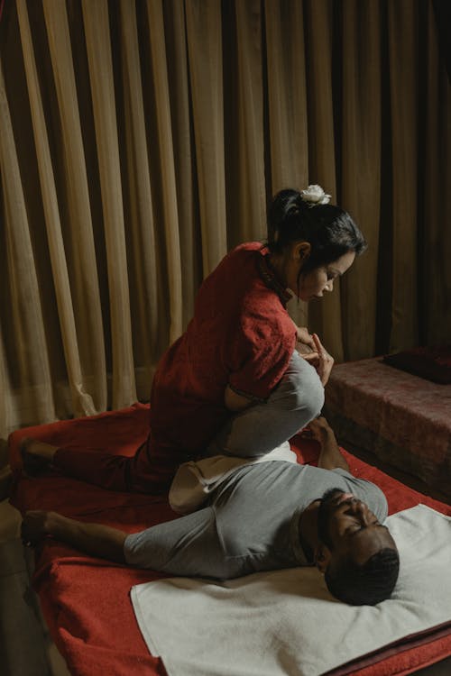 Free A Woman Massaging a Man's Leg Stock Photo