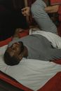 Man in Gray Long Sleeve Shirt Lying on Bed