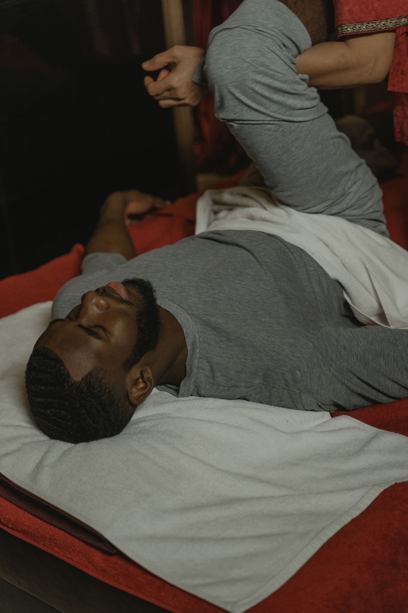 Black man receiving a professional leg massage at a spa