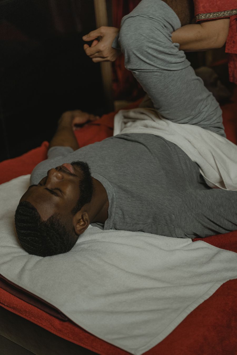 African man relaxing during a full body spa massage