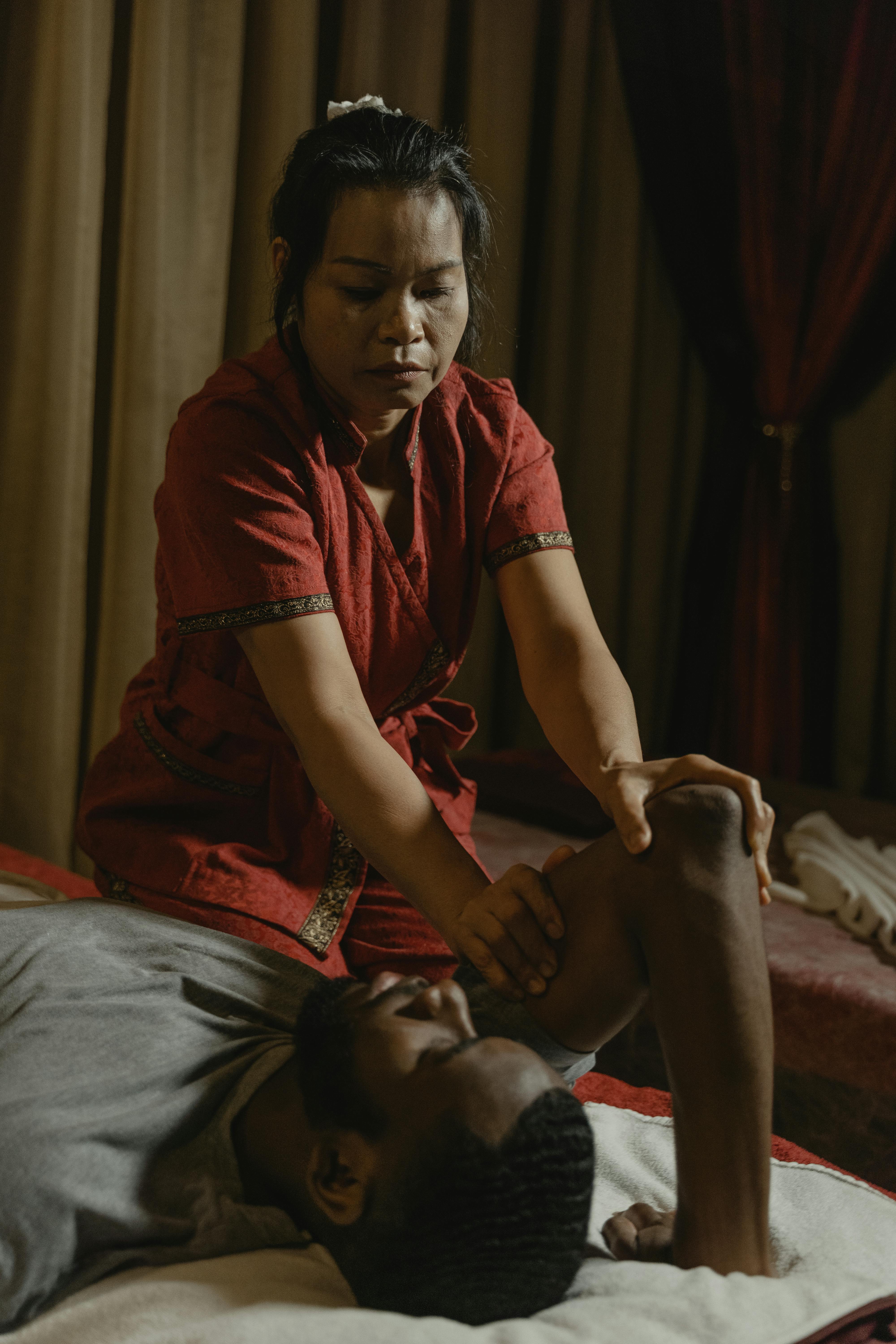 a woman doing a massage to a man s arm