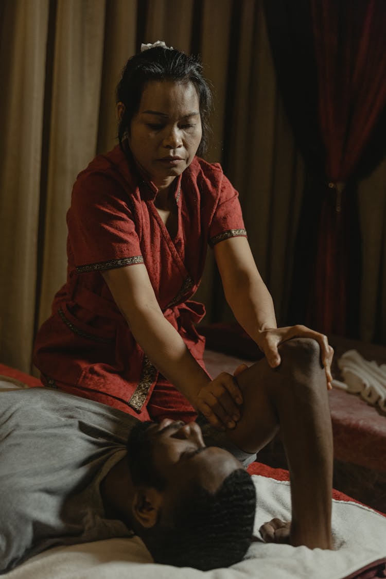 A Woman Doing A Massage To A Man's Arm