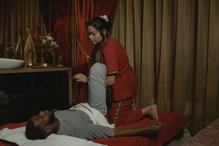 A Woman Doing A Body Massage To A Man