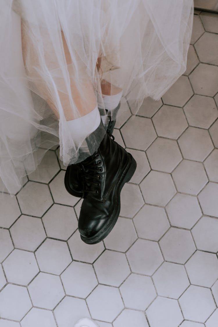 
A Bride Wearing Black Leather Boots