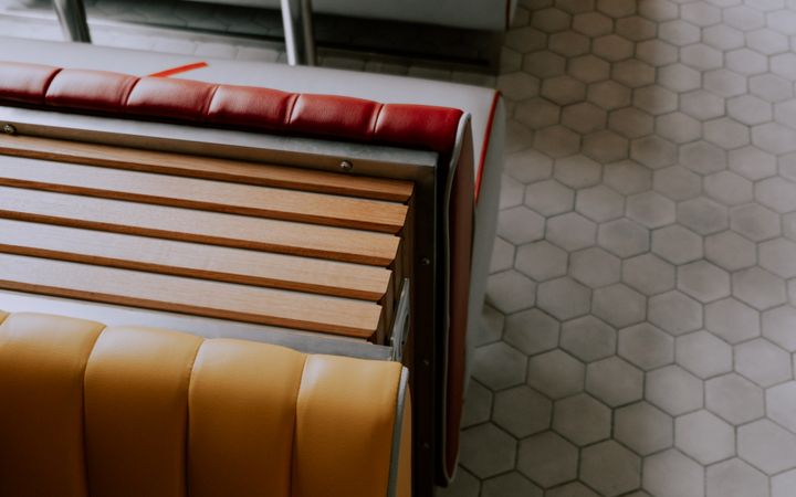 Stylish retro diner seating with colorful booths and hexagonal floor tiles.