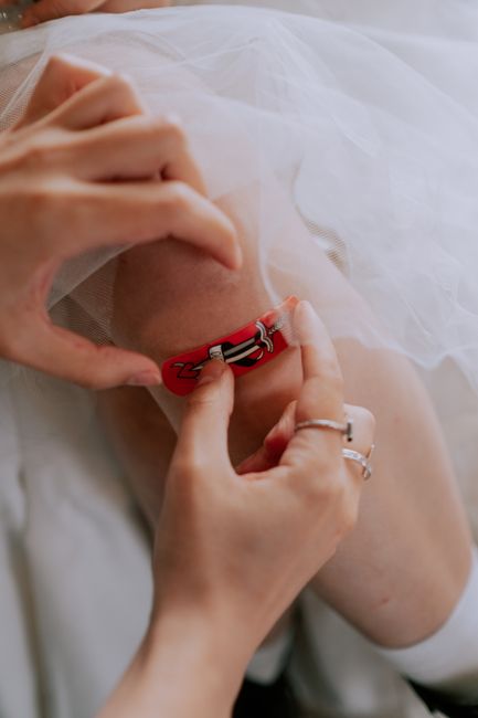 Hands applying an adhesive waterproof bandage to a knee