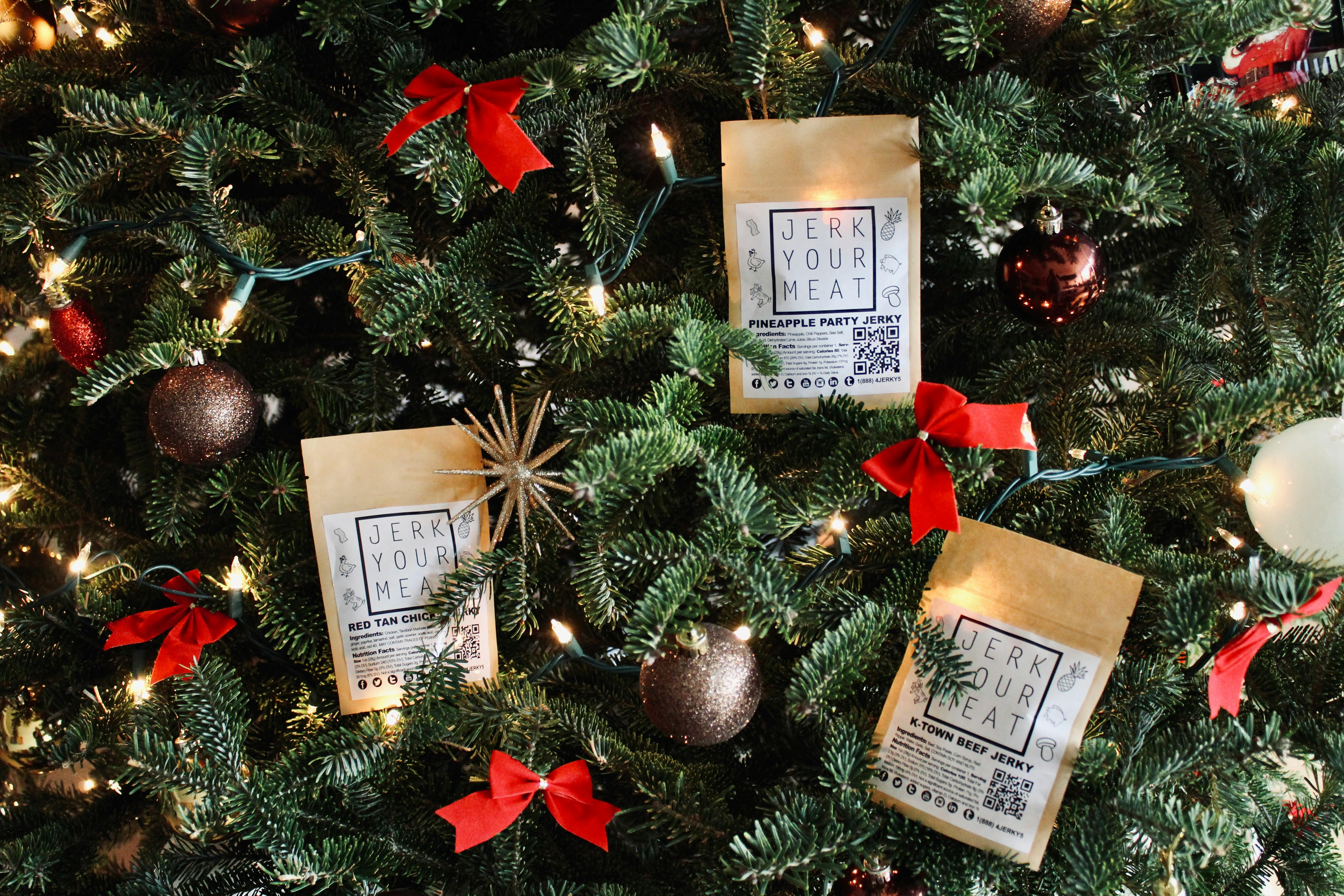 Christmas tree adorned with jerky meat packages, baubles, and red bows, creating a festive atmosphere.