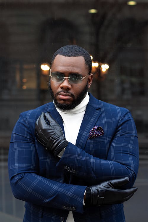 

A Bearded Man Wearing a Plaid Suit and Leather Gloves