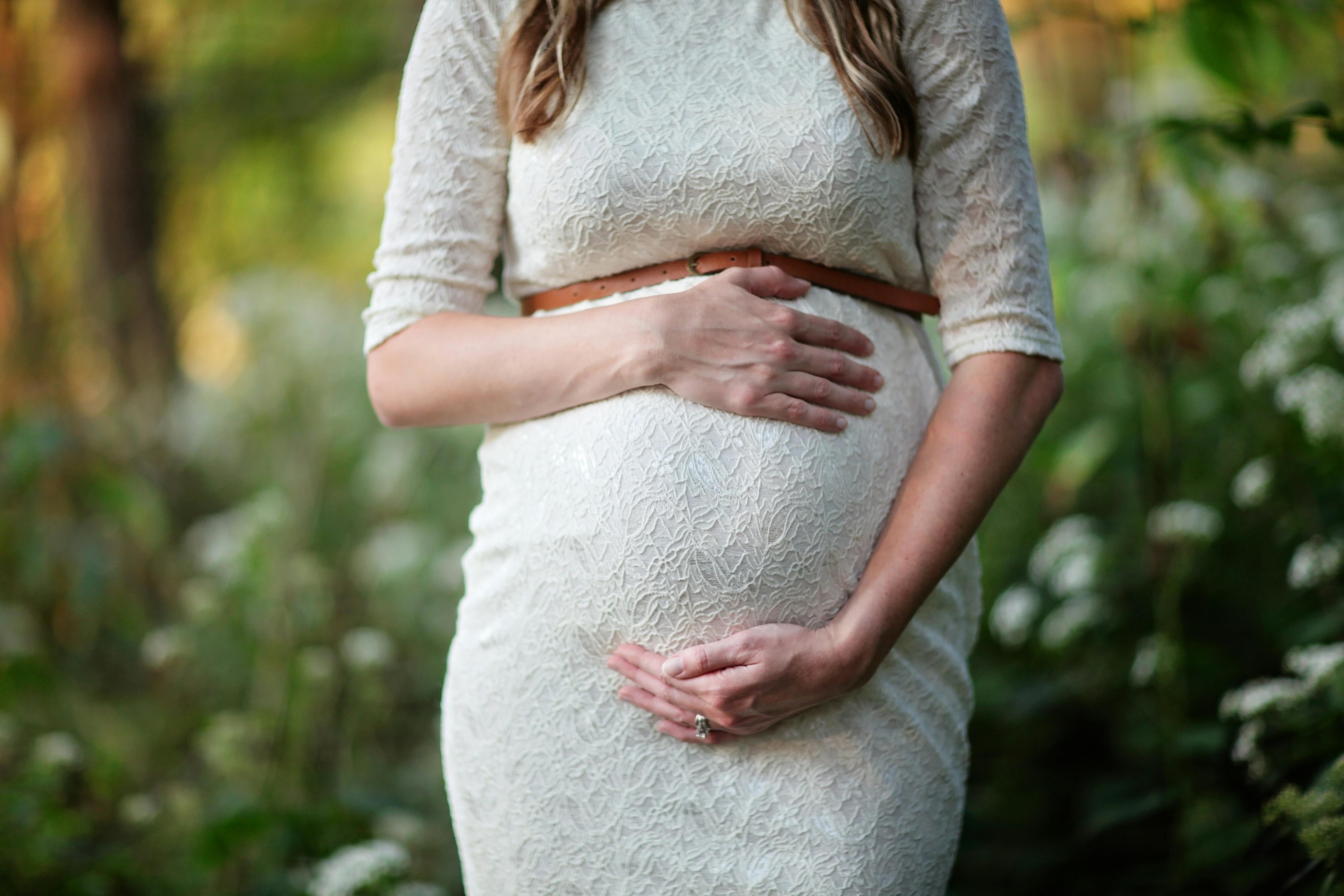 Future Parents Posing Together at a Pregnancy Photoshoot · Free Stock Photo