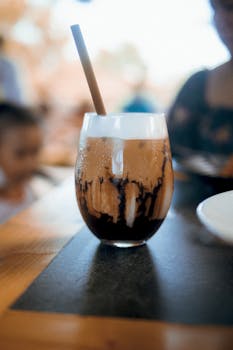 Delicious iced mocha with chocolate drizzle in a cozy café ambiance.