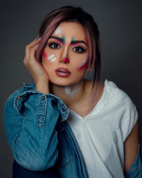 Close Up Photo of Woman with Paint on Her Face